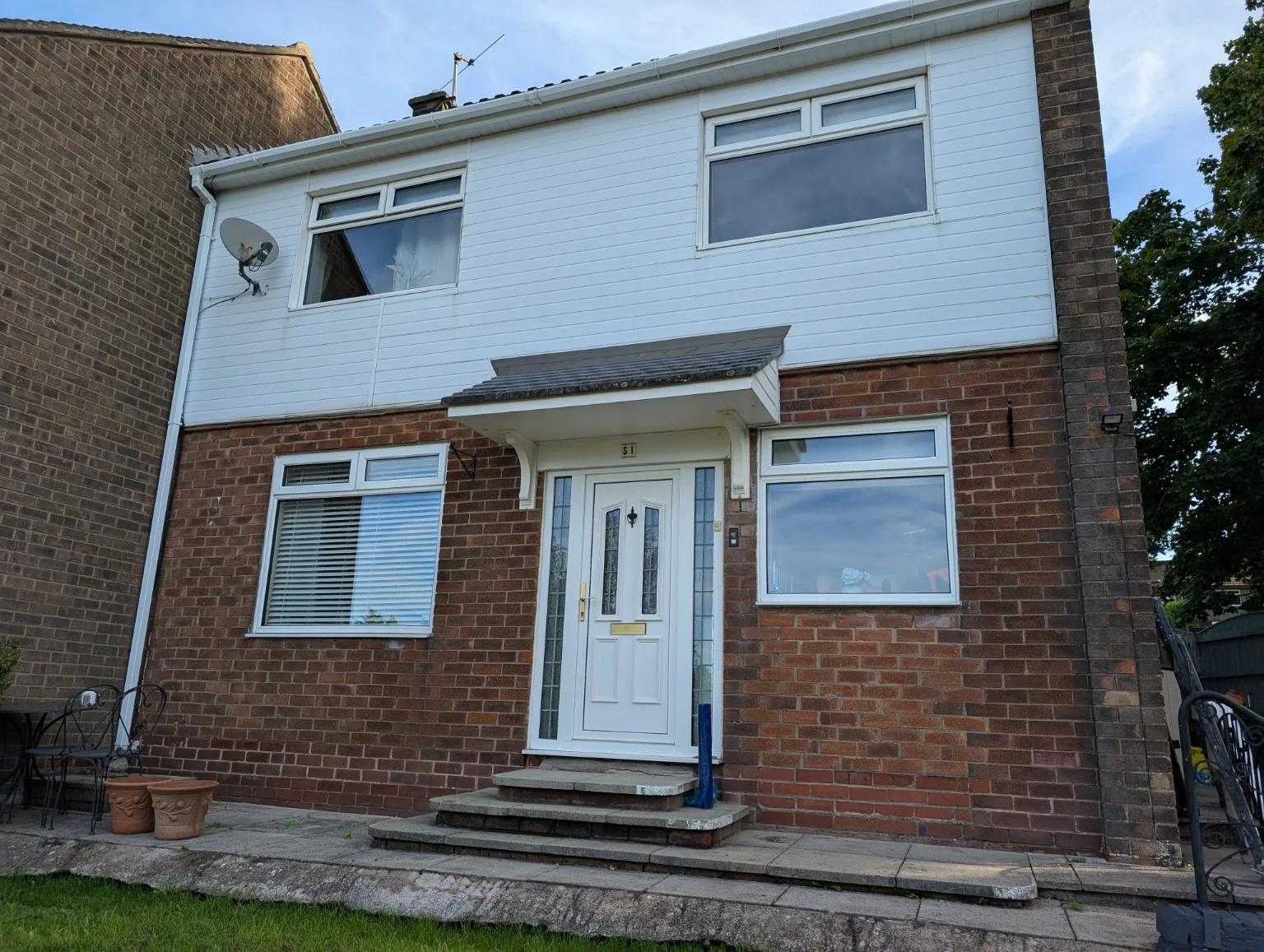 Brick house before repointing with weathered and inconsistent mortar joints