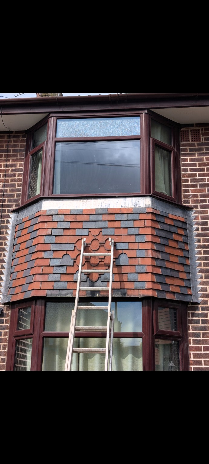 Detailed brick bay window showing contrasting red and blue bricks